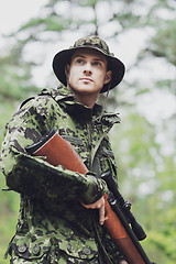 Image showing young soldier or hunter with gun in forest