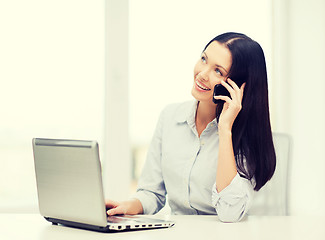 Image showing businesswoman with laptop and cell phone