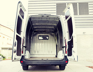 Image showing empty minivan car with open doors on city parking