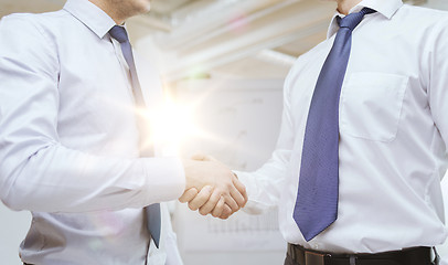 Image showing two businessmen shaking hands in office