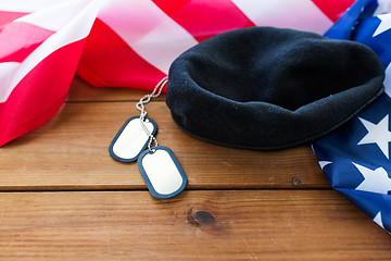 Image showing close up of american flag, hat and military badge