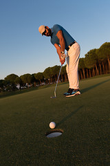 Image showing golfer  hitting shot at golf course