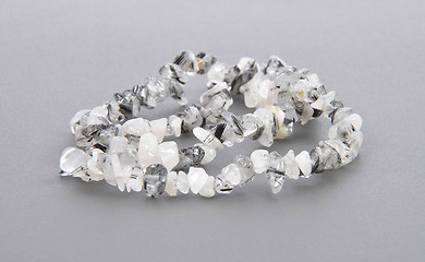 Image showing Splintered tourmaline quartz chain on gray background