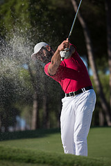 Image showing golfer hitting a sand bunker shot
