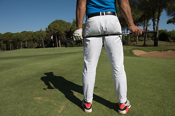 Image showing golf player close up hand and driver from back