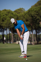 Image showing golf player hitting shot at sunny day