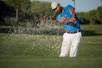 Image showing pro golfer hitting a sand bunker shot