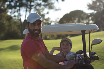 Image showing couple in buggy on golf course