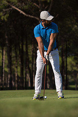 Image showing golf player hitting shot