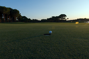 Image showing golf ball on edge of  the hole