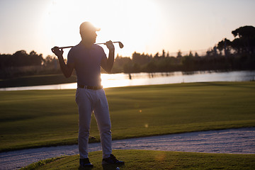 Image showing golfer  portrait at golf course on sunset