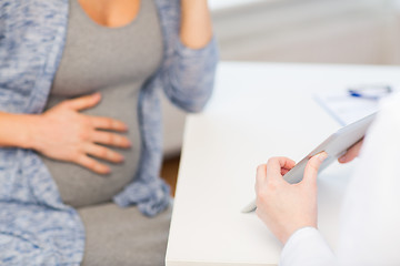 Image showing close up of doctor with tablet and pregnant woman