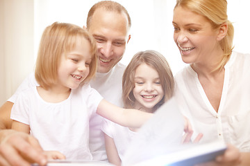 Image showing happy family reading book at home