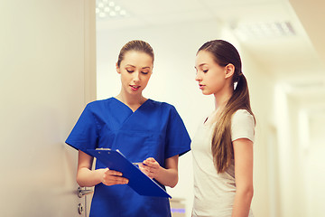 Image showing doctor or nurse with clipboard and girl patient