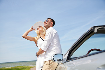 Image showing happy couple hugging near cabriolet car at sea