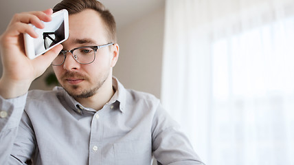 Image showing businessman with smarphone at home office