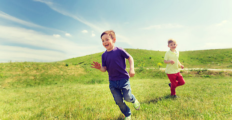 Image showing happy little boys running outdoors