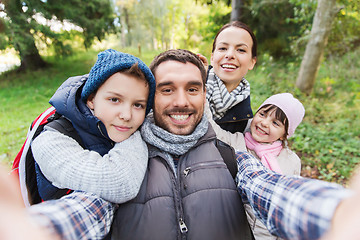 Image showing family with backpacks taking selfie and hiking