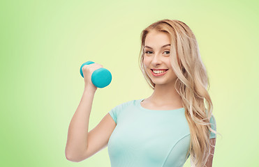 Image showing smiling beautiful young sporty woman with dumbbell