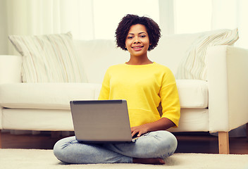 Image showing happy african american woman with laptop at home