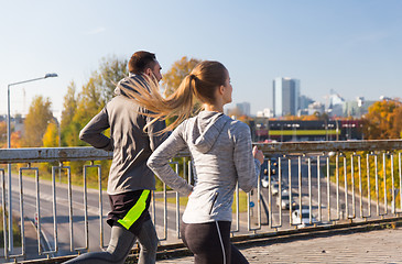 Image showing happy couple running outdoors