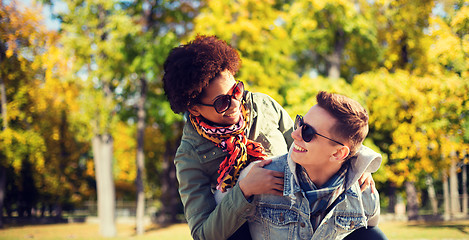 Image showing happy teenage couple in shades having fun outdoors