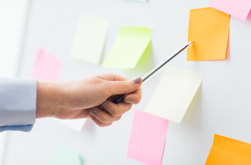 Image showing close up of hand pointing to sticker on flip chart