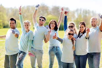 Image showing group of volunteers showing thumbs up in park