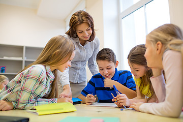 Image showing group of school kids writing test in classroom