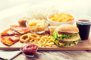 Image showing close up of fast food snacks and drink on table