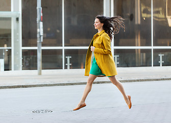 Image showing happy young woman or teenage girl on city street