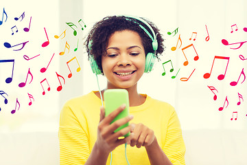 Image showing happy african woman with smartphone and headphones