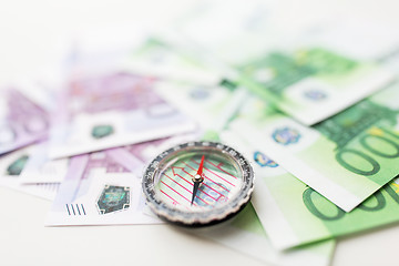 Image showing close up of compass and euro money on table