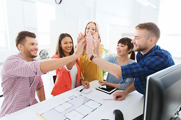 Image showing creative team making high five at office