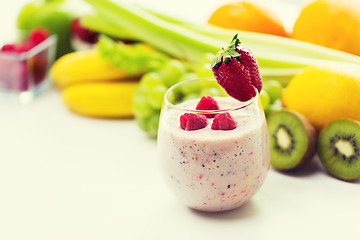 Image showing close up of glass with milk shake and fruits