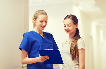 Image showing doctor or nurse with clipboard and girl patient