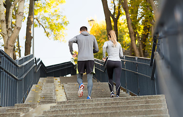 Image showing couple running upstairs in city park