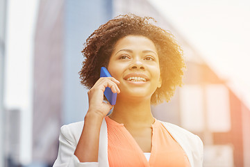 Image showing happy african businesswoman calling on smartphone