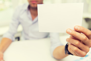 Image showing close up of businessman with blank paper at office