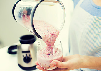 Image showing close up of woman with blender and shake at home