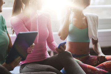 Image showing close up of happy women listening to music in gym