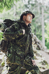 Image showing young soldier with backpack in forest