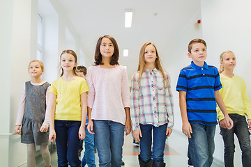 Image showing group of smiling school kids walking in corridor