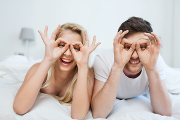 Image showing happy couple lying in bed at home