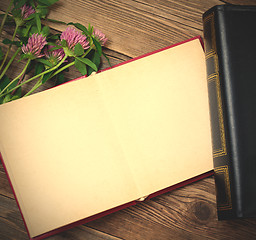 Image showing Flat lay with photo album and flowers