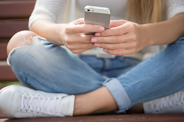 Image showing beautiful girl on the street corresponded by phone. 