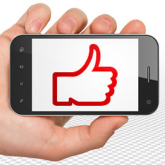 Image showing Social network concept: Hand Holding Smartphone with Thumb Up on display