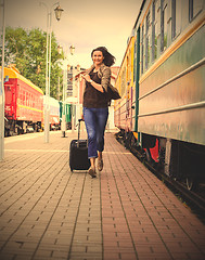 Image showing woman with luggage on the station platform