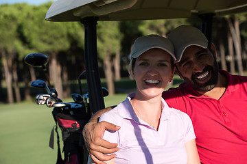 Image showing couple in buggy on golf course