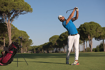 Image showing golf player hitting shot